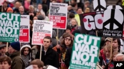 Protestors hold up banners as they gather in Trafalgar Square, central London during a Stop The War demonstration on November 20, 2010 against the continued involvement of Britain in the war in Afghanistan.