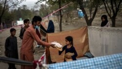 Para warga Afghanistan yang kehilangan tempat tinggal saling berbagi makanan yang didapat dari program donasi di salah satu kamp pengungsi di Kabul, pada 13 September 2021. (Foto: AP/Bernat Armangue)