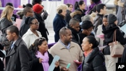 A crowd of job seekers attends a health care job fair in New York, March 14, 2013.