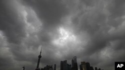 Dark clouds cover the financial district of Shanghai, August 6, 2011, as typhoon Muifa approaches the Chinese province of Zhejiang