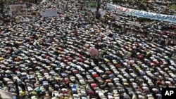Protesters conduct Friday Prayers in Tahrir square in Cairo. Thousands of Egyptians converged on Cairo's Tahrir square on Friday in what organizers called a "second revolution" to push for deeper reforms and a speedy trial for ousted President Hosni Mubar
