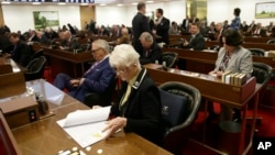 Rep. Julia Craven Howard, R-Davie, foreground, and other North Carolina lawmakers gather for a special session Wednesday, March 23, 2016.