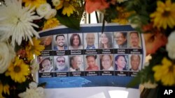 FILE - Pictures of Wednesday's shooting victims are displayed at a makeshift memorial site in San Bernardino, Calif., Dec. 7, 2015.