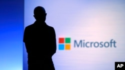 In this May 7, 2018, file photo Microsoft CEO Satya Nadella looks on during a video as he delivers the keynote address at Build, the company's annual conference for software developers in Seattle. (AP Photo/Elaine Thompson, File)