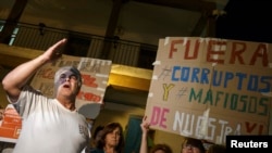 A man shouts slogans against corruption during a protest outside Madrid.