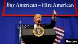 U.S. President Donald Trump speaks before signing an executive order directing federal agencies to recommend changes to a temporary visa program used to bring foreign workers to the United States to fill high-skilled jobs during a visit to the world headq