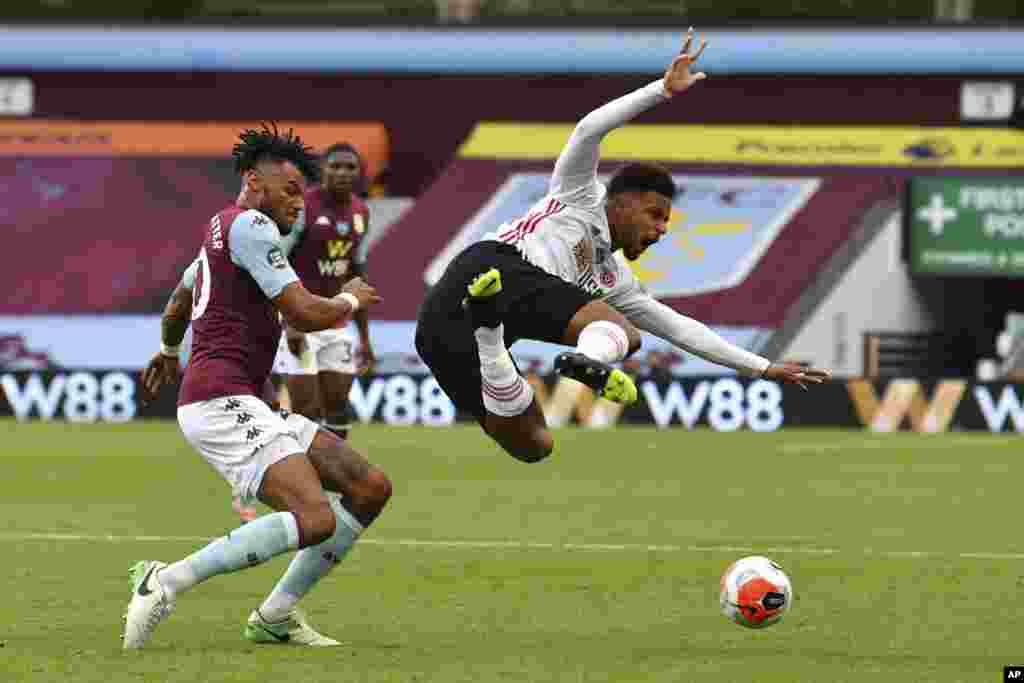 Sheffield United&#39;s Mbwana Samatta, right, is brought down by Aston Villa&#39;s Tyrone Mings during the English Premier League soccer game between Aston Villa and Sheffield United at Villa Park in Birmingham, England, June 17, 2020.