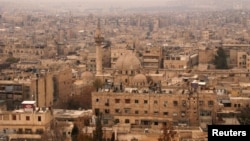 A general view shows the Old City of Aleppo as seen from Aleppo's historic citadel, Syria, Dec. 11, 2009. A similar view is seen below from Oct. 2016. 