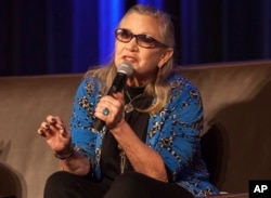 FILE - Carrie Fisher speaks during Wizard World Chicago Comic-Con at the Donald E. Stephens Convention Center in Chicago, Aug. 21, 2016.