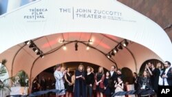 Tribeca Film Festival co-founder Jane Rosenthal, center, and Susan Zuccotti, right, and Zuccotti family cut the ribbon of the newly named John Zuccotti Theater before the Tribeca Film Festival opening night world premiere of "The First Monday in May" at BMCC Tribeca Performing Arts Center, April 13, 2016, in New York. 