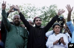 FILE - Manzoor Pashteen, center, leader of the Pashtun Protection Movement waves to his supporters during a rally in Lahore, Pakistan, April 22, 2018.