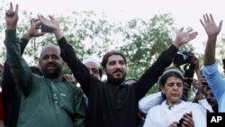 FILE - Manzoor Pashteen, center, leader of the Pashtun Protection Movement waves to his supporters during a rally in Lahore, Pakistan, April 22, 2018.