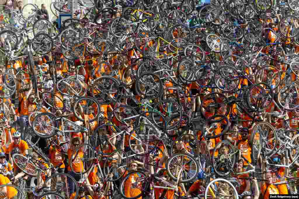 Thousands of cyclists raise their bikes during a march called &quot;I Bike Budapest&quot; in Budapest, Hungary, 23 April 2016.&nbsp;The mass parade was organized by the Hungarian Cyclists&#39; Club to urge officials to build further tracks for cyclists in the streets and on the roads.