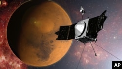 In this artist concept provided by NASA, the MAVEN spacecraft approaches Mars on a mission to study its upper atmosphere. 