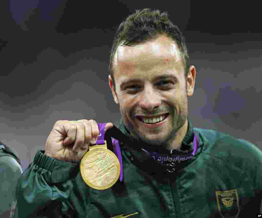 Pistorius celebrates with his gold medal after winning the men's 400m T44 classification during the London 2012 Paralympic Games, September 8, 2012.