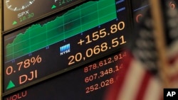 A screen on the New York Stock Exchange shows a popular measure of stock prices, the Dow Jones Industrial average reaching above 20,000 points on January 25, 2017.