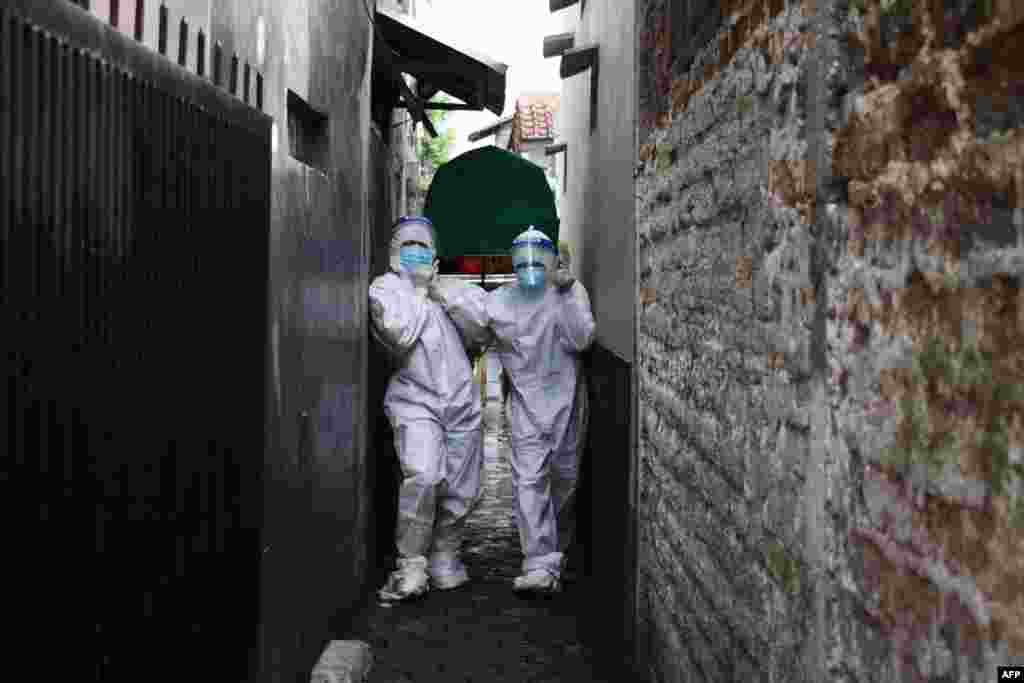 Health workers remove the body of a man who died of Covid-19 coronavirus at his Home in Bandung as Indonesia&rsquo;s infection rates soar and hospitals are flooded with new patients, prompting warnings that the Southeast Asian nation&#39;s health crisis could spiral out of control.