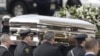 The coffin holding the remains of singer Whitney Houston is carried to a hearse in February 2012, after funeral services in New Jersey, which were seen by millions online. 