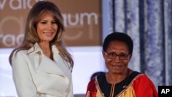 First lady Melania Trump presents the 2017 Secretary's of State's International Women of Courage (IWOC) Award to Veronica Simogun from Papua New Guinea, March 29, 2017, at the State Department in Washington.