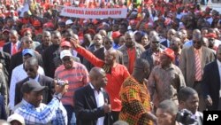 Leader of the main opposition party, Nelson Chamisa, centre, waves at supporters during a march on the streets of Harare, Wednesday, July 11, 2018. 