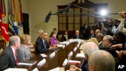 President Barack Obama makes a statement before the start of a meeting with representatives of health insurance companies, in the Roosevelt Room of the White House, in Washington, Nov. 15, 2013.