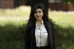 In this photo taken on Thursday, June 11, 2020, recent university graduate Sahar Shabani poses for a photograph in London. Shabani, 22, did a three-month remote internship with a development charity based in Thailand from her parents' home in South London