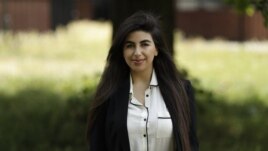 In this photo taken on Thursday, June 11, 2020, recent university graduate Sahar Shabani poses for a photograph in London. Shabani, 22, did a three-month remote internship with a development charity based in Thailand from her parents' home in South London