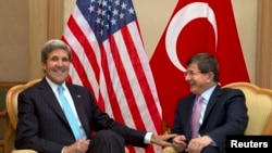 U.S. Secretary of State John Kerry (L) meets with Turkey's Foreign Minister Ahmet Davutoglu before attending the Association of Southeast Asian Nations (ASEAN) security meetings in Bandar Seri Begawan, July 2, 2013.