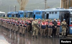 Turkish soldiers accused of attempting to assassinate President Tayyip Erdogan on the night of the failed July 15 coup, are escorted by gendarmes as they arrive at the court in Mugla, Turkey, March 8, 2017.