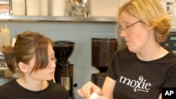 At Moxie Bakery and Cafe, Christina Quinn (L) gets advice from Elin Ross on more than how to bake cupcakes