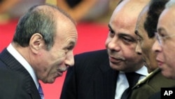 Former Egyptian Interior Minister Habib al-Adly, left, as he talks to minister of defense and military production, Field Marshal Hussein Tantawi, second right, during the National democratic party conference in Cairo, December 25, 2010