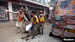 파키스탄 북서부 페샤와르에서 29일 폭탄 테러가 발생한 가운데, 구조대원이 부상자를 옮기고 있다.