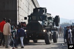 FILE - An Indian armored vehicle moves near an Indian air force base in Pathankot, 430 kilometers (267 miles) north of New Delhi, India, Jan. 2, 2016. Gunmen attacked the air force base near the border with Pakistan early Saturday.