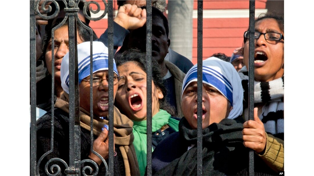 FILE - Indian Christians shout slogans protesting attacks on churches in the Indian capital as they assemble outside the Sacred Heart Church in New Delhi, India, Feb. 5, 2015.