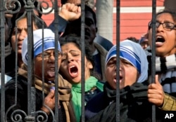 FILE - Indian Christians shout slogans protesting attacks on churches in the Indian capital as they assemble outside the Sacred Heart Church in New Delhi, India, Feb. 5, 2015.