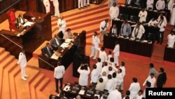 Sri Lanka's parliament members argue in front of Speaker of the Parliament Karu Jayasuriya during the parliament session in Colombo, Sri Lanka, Nov. 14, 2018.