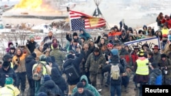 Opponents of the Dakota Access oil pipeline march out of their main camp near Cannon Ball, North Dakota, U.S., Feb. 22, 2017.