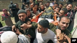 Palestinians carry the body of Islamic Jihad militant Saber Asalya during his funeral at Jabalya refugee camp in the northern Gaza Strip after Israeli aircraft killed two Palestinian militants, one of them Asalya, March 27, 2011