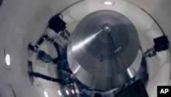 FILE - An inert Minuteman 3 missile sits in a training launch tube at Minot Air Force Base, N.D., June 25, 2014. The base is tasked with maintaining 150 of the nuclear-tipped missiles spread out across the North Dakota countryside and keeping them ready to launch.