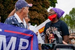 Supporters of both President Donald Trump and Black Lives Matters clash in a park outside the Kenosha County Courthouse, Tuesday, Sept. 1, 2020, in Kenosha, Wis. (AP Photo/Morry Gash)