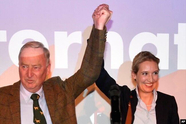 AfD top candidates Alexander Gauland, left, and Alice Weidel celebrate with their supporters during the election party of the nationalist 'Alternative for Germany', AfD, in Berlin, Sept. 24, 2017.
