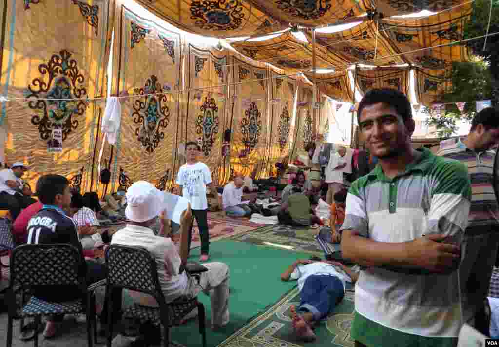 Fifteen-year-old Abdulrahman Usama has been staying in this tent for nearly a month and says he won't go back to school until the former president is reinstated. (Heather Murdock for VOA)