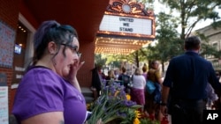 Cynthia Sullivan of Charlottesville, Va., stands in line for a memorial service for Heather Heyer, who was killed during a white nationalist rally, in Charlottesville, Va., Aug. 16, 2017.