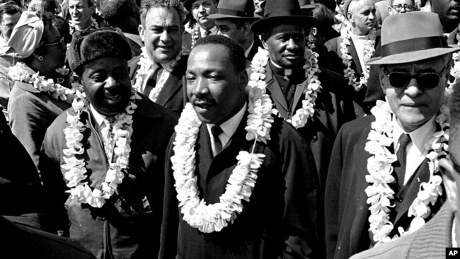 FILE - Martin Luther King Jr. and other civil rights marchers cross the Edmund Pettus Bridge in Selma, Ala., March 21, 1965.