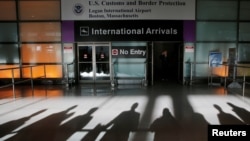 An international traveler arrives after President Donald Trump issues a travel ban restricting admittance to the U.S. of citizens from seven countries, at Logan Airport in Boston, Massachusetts, Jan. 30, 2017. 