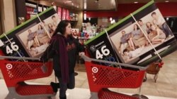 A shopper in California guides her televisions out of a store last month