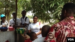 FILE - Zero Ebola Campaign volunteers talk to residents in Freetown, Sierra Leone, March 27, 2015. ( Nina deVries/VOA)