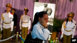 A woman weeps as she pays her final respects to the late leader Fidel Castro at Revolution Plaza in Havana, Cuba, Nov. 28, 2016. Castro died Friday at the age of 90.