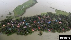 An aerial view shows partially submerged houses at a flooded area in the southern state of Kerala, Aug. 19, 2018. 