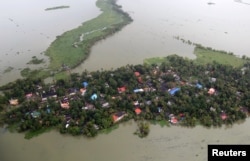 An aerial view shows partially submerged houses at a flooded area in the southern state of Kerala, Aug. 19, 2018.